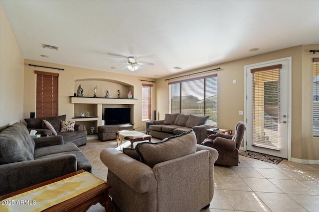 tiled living room featuring ceiling fan