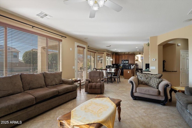 tiled living room featuring ceiling fan