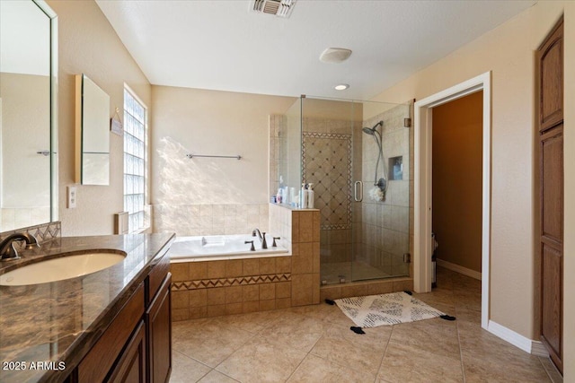 bathroom with tile patterned floors, vanity, and separate shower and tub