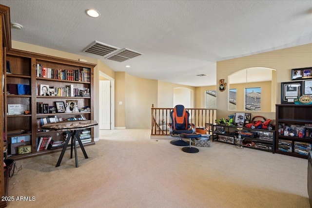 interior space with light colored carpet and a textured ceiling