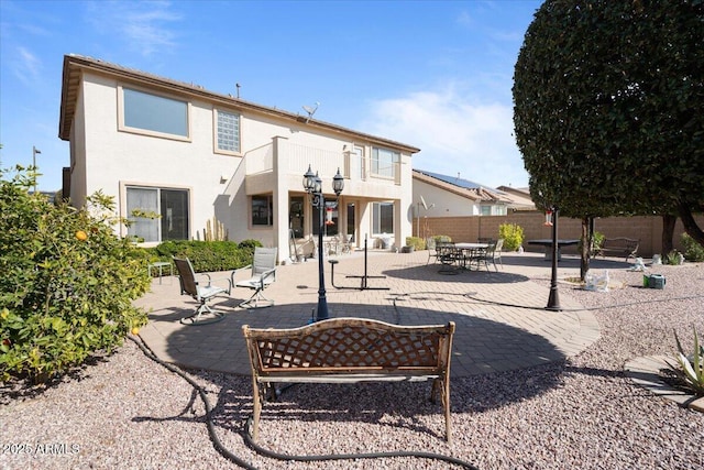 rear view of house featuring a patio area and a balcony