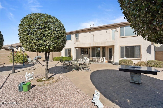 back of property featuring a patio and a balcony