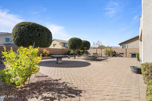 view of patio featuring a grill