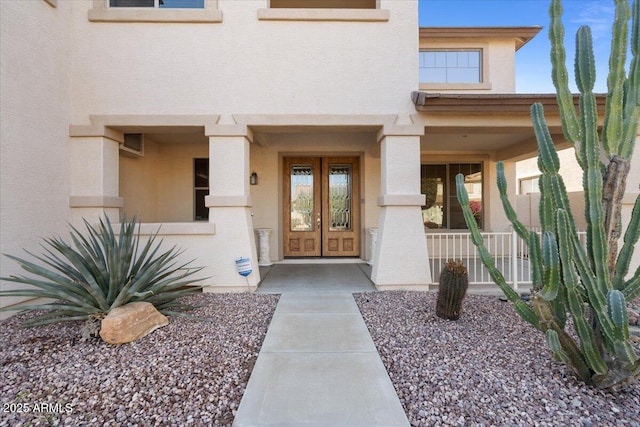 view of exterior entry featuring covered porch