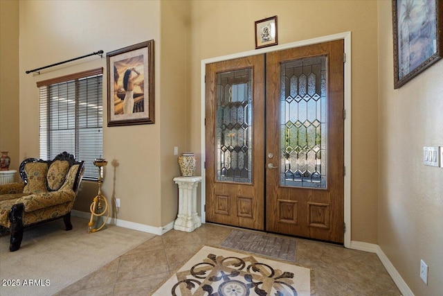 tiled entryway with french doors and a wealth of natural light