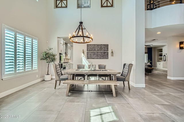 1890 E Sagittarius Pl, Chandler, AZ 85249 - dining area featuring a towering ceiling, a chandelier, baseboards, and light tile patterned floors