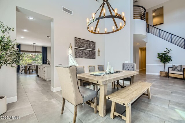 1890 E Sagittarius Pl, Chandler, AZ 85249 - dining area with a chandelier, baseboards, recessed lighting, a high ceiling, and light tile patterned flooring