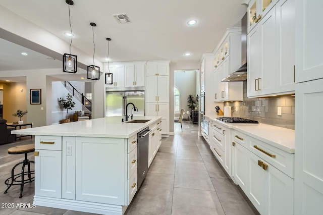 1890 E Sagittarius Pl, Chandler, AZ 85249 - kitchen with wall chimney exhaust hood, glass insert cabinets, a kitchen bar, light countertops, and recessed lighting