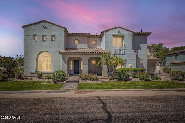1890 E Sagittarius Pl, Chandler, AZ 85249 - mediterranean / spanish home featuring stucco siding, a tiled roof, a yard, a porch, and a garage