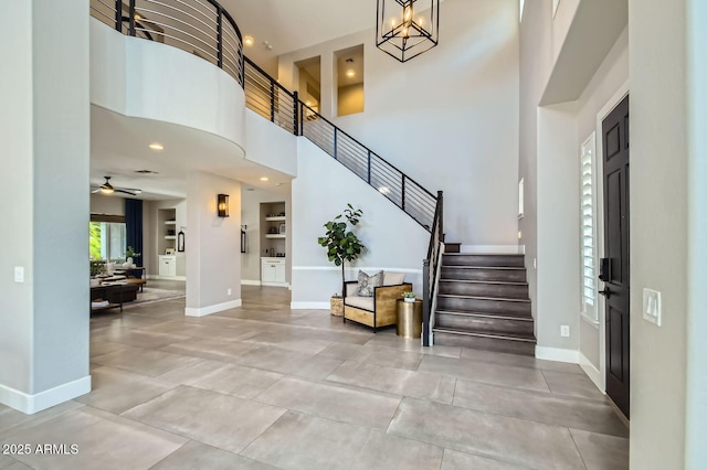 1890 E Sagittarius Pl, Chandler, AZ 85249 - entrance foyer featuring baseboards, stairway, a ceiling fan, a high ceiling, and tile patterned flooring