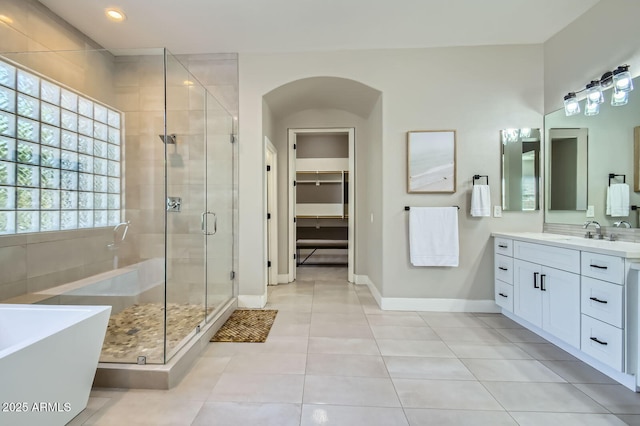 1890 E Sagittarius Pl, Chandler, AZ 85249 - full bath featuring a stall shower, baseboards, tile patterned flooring, a soaking tub, and vanity