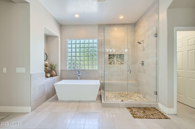 1890 E Sagittarius Pl, Chandler, AZ 85249 - bathroom with a stall shower, tile patterned floors, a freestanding tub, baseboards, and recessed lighting