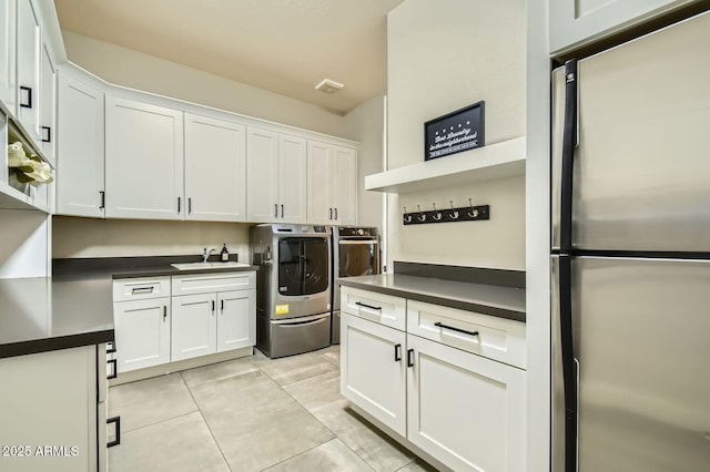 1890 E Sagittarius Pl, Chandler, AZ 85249 - laundry area with washing machine and clothes dryer, cabinet space, and light tile patterned flooring