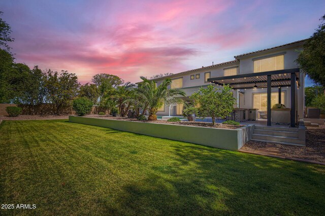 1890 E Sagittarius Pl, Chandler, AZ 85249 - yard at dusk featuring a yard, a ceiling fan, and central AC unit