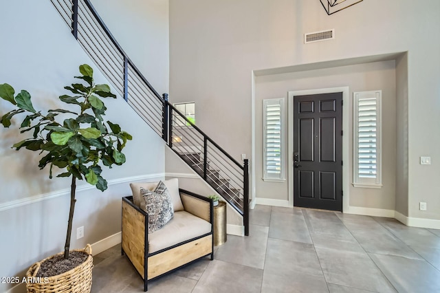 1890 E Sagittarius Pl, Chandler, AZ 85249 - entrance foyer with stairway, a high ceiling, baseboards, and concrete floors
