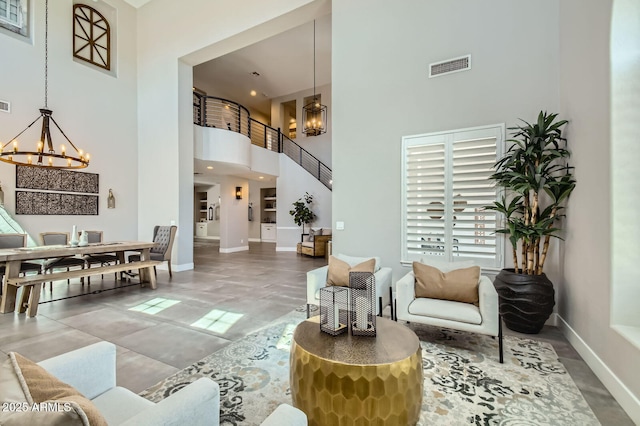 1890 E Sagittarius Pl, Chandler, AZ 85249 - living area featuring a chandelier, a towering ceiling, and baseboards
