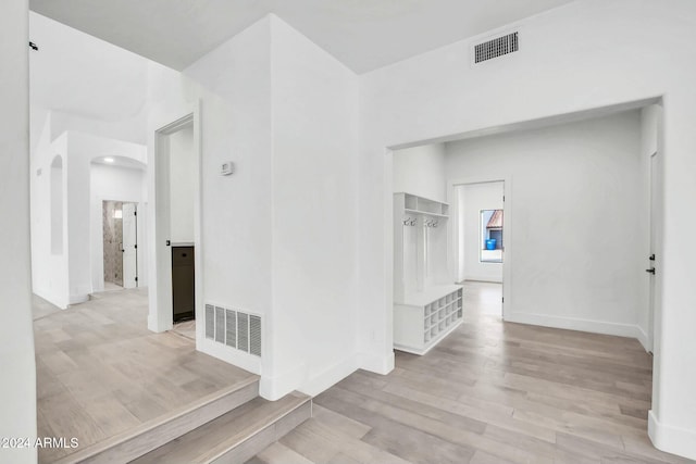 corridor with light hardwood / wood-style flooring