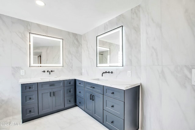 bathroom with vanity and tile walls