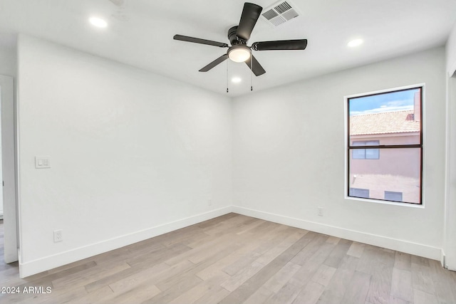 spare room featuring ceiling fan and light hardwood / wood-style floors