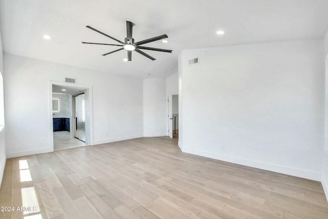 spare room with ceiling fan and light hardwood / wood-style flooring