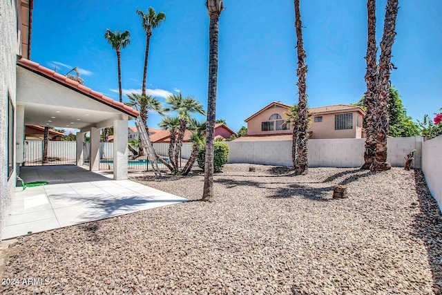 view of yard featuring a fenced in pool and a patio