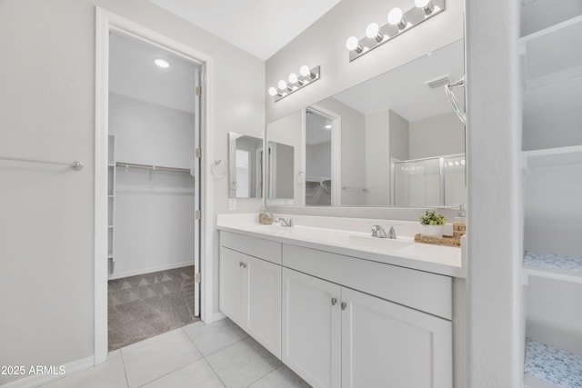 8944 N 180th Dr, Waddell, AZ 85355 - full bathroom with a walk in closet, double vanity, a sink, and tile patterned flooring