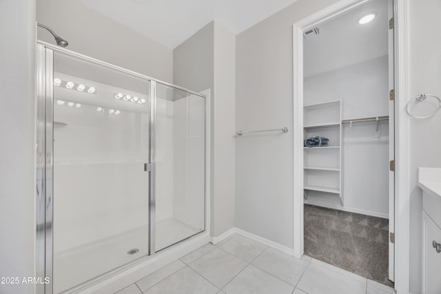 8944 N 180th Dr, Waddell, AZ 85355 - full bathroom with a shower stall, vanity, a spacious closet, visible vents, and tile patterned floors