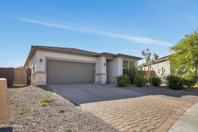 8944 N 180th Dr, Waddell, AZ 85355 - view of front facade featuring an attached garage, a gate, stucco siding, and decorative driveway