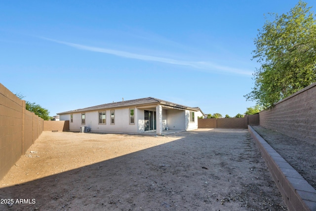 8944 N 180th Dr, Waddell, AZ 85355 - rear view of property featuring a fenced backyard, stucco siding, and central AC unit
