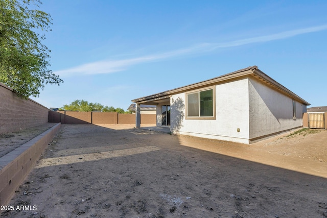 8944 N 180th Dr, Waddell, AZ 85355 - back of house with a fenced backyard, a tile roof, and stucco siding