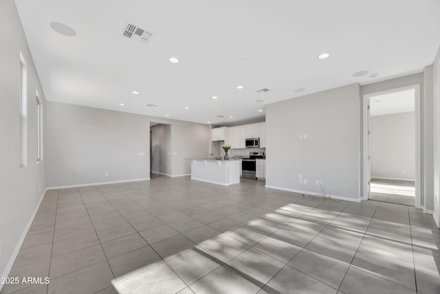 8944 N 180th Dr, Waddell, AZ 85355 - unfurnished living room featuring recessed lighting, light tile patterned floors, and visible vents
