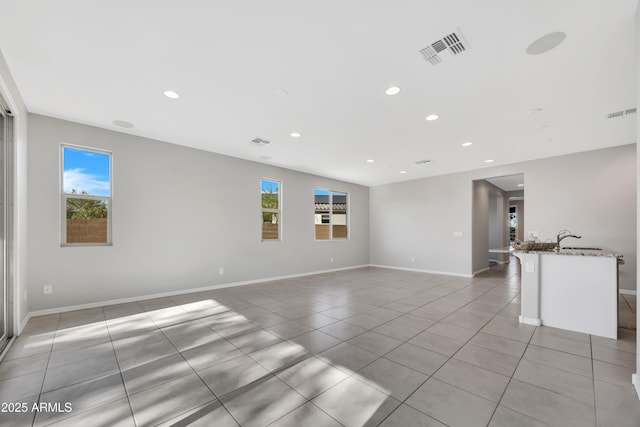 8944 N 180th Dr, Waddell, AZ 85355 - empty room featuring a healthy amount of sunlight, light tile patterned flooring, and visible vents