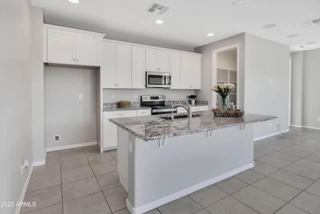 8944 N 180th Dr, Waddell, AZ 85355 - kitchen with appliances with stainless steel finishes, light tile patterned flooring, a sink, and visible vents