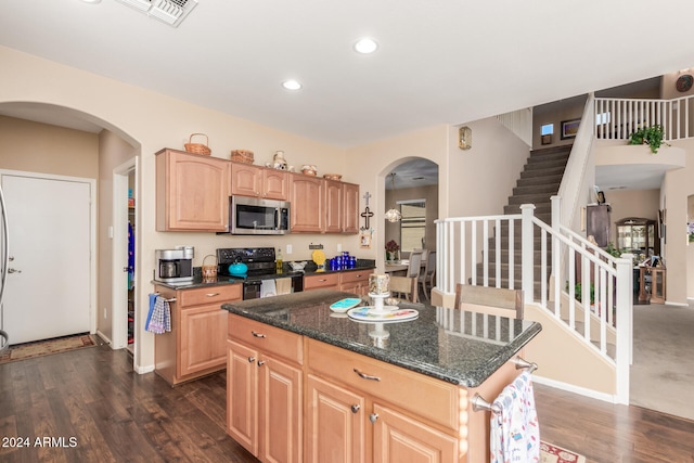 kitchen with black range with electric cooktop, dark stone counters, a kitchen island, and dark wood-type flooring