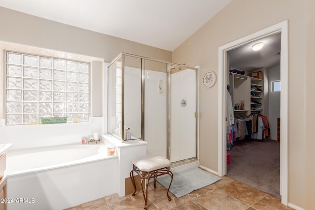 bathroom featuring independent shower and bath and vaulted ceiling