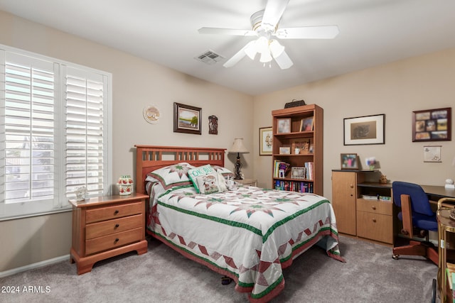 carpeted bedroom with ceiling fan and multiple windows