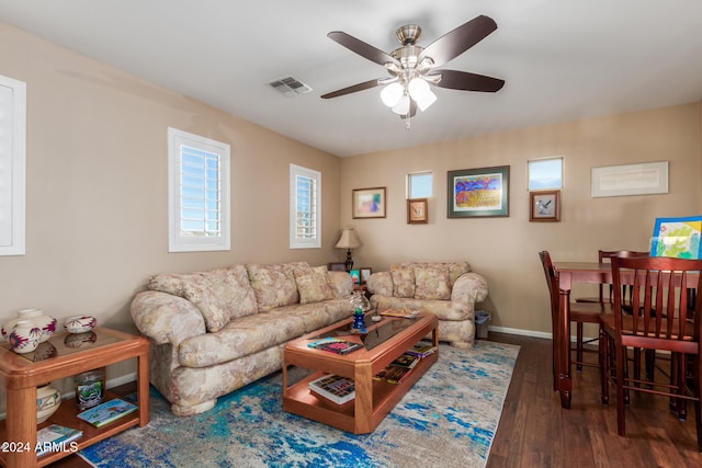 living room featuring dark hardwood / wood-style floors and ceiling fan