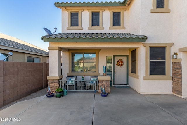 entrance to property with a patio