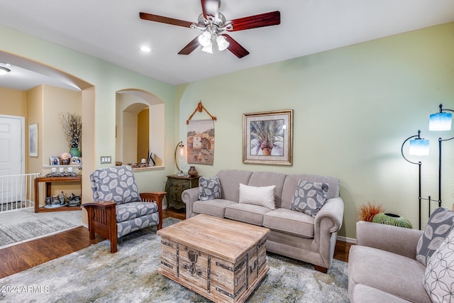 living room with light wood-type flooring and ceiling fan