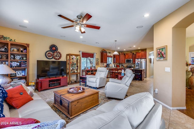 living room featuring ceiling fan and light tile patterned floors