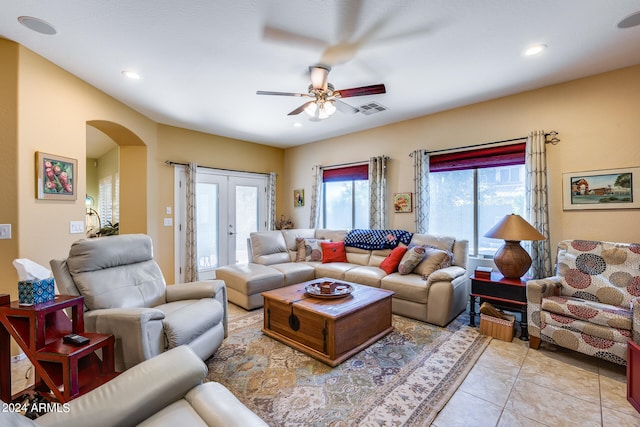 living room featuring ceiling fan, french doors, light tile patterned floors, and a wealth of natural light