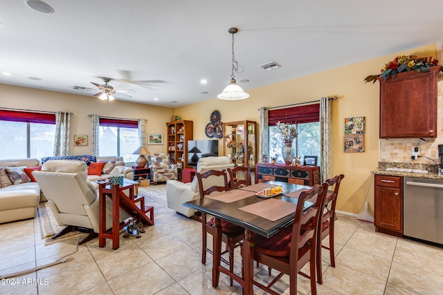 tiled dining room featuring ceiling fan