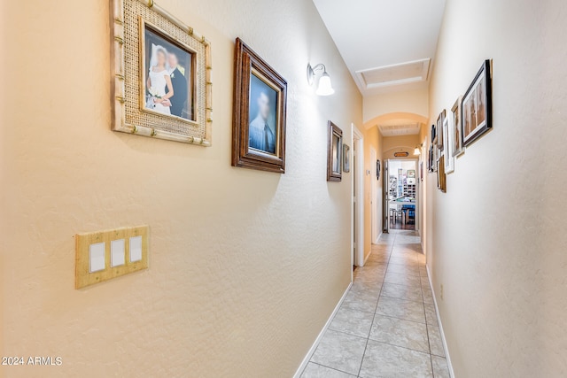 hall featuring light tile patterned floors