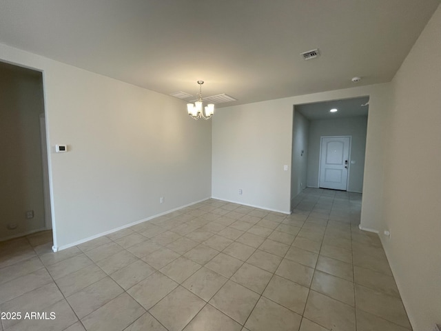 spare room with baseboards, visible vents, light tile patterned floors, and a chandelier