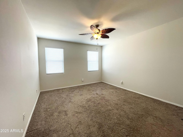 unfurnished room with a ceiling fan, carpet, and baseboards
