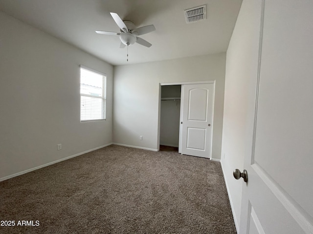 unfurnished bedroom with a closet, baseboards, visible vents, ceiling fan, and carpet