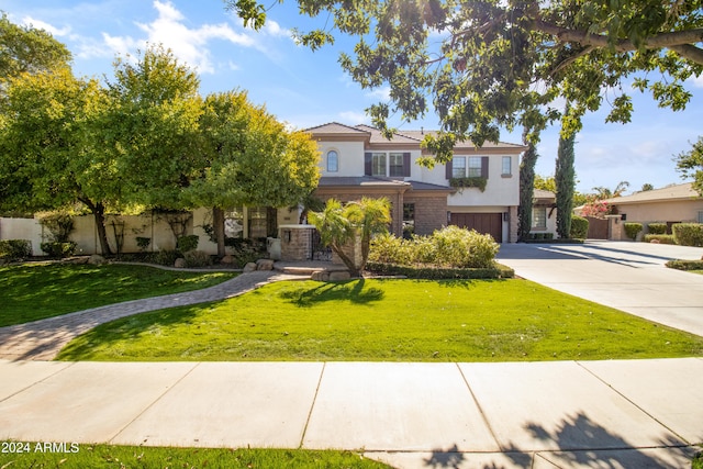 view of front of house with a garage and a front lawn