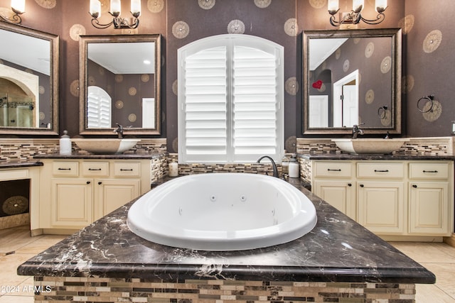 bathroom featuring tile patterned floors, tiled bath, vanity, and a healthy amount of sunlight