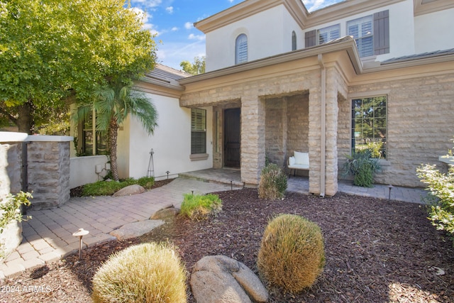 entrance to property featuring a patio area