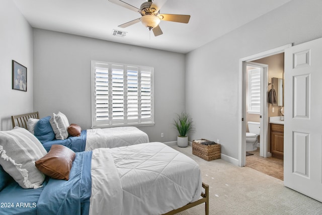 carpeted bedroom with ceiling fan and ensuite bathroom